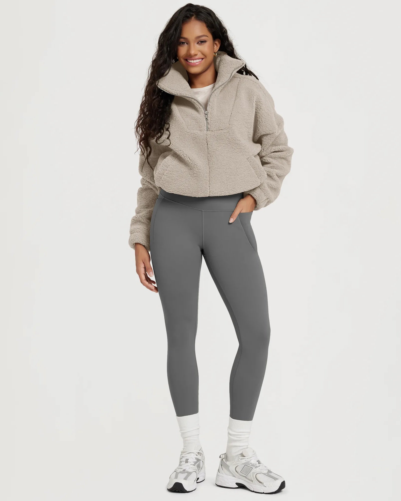 Model showcasing 25" Fleece Lined Leggings with Pockets, paired with a cozy pullover and sneakers.