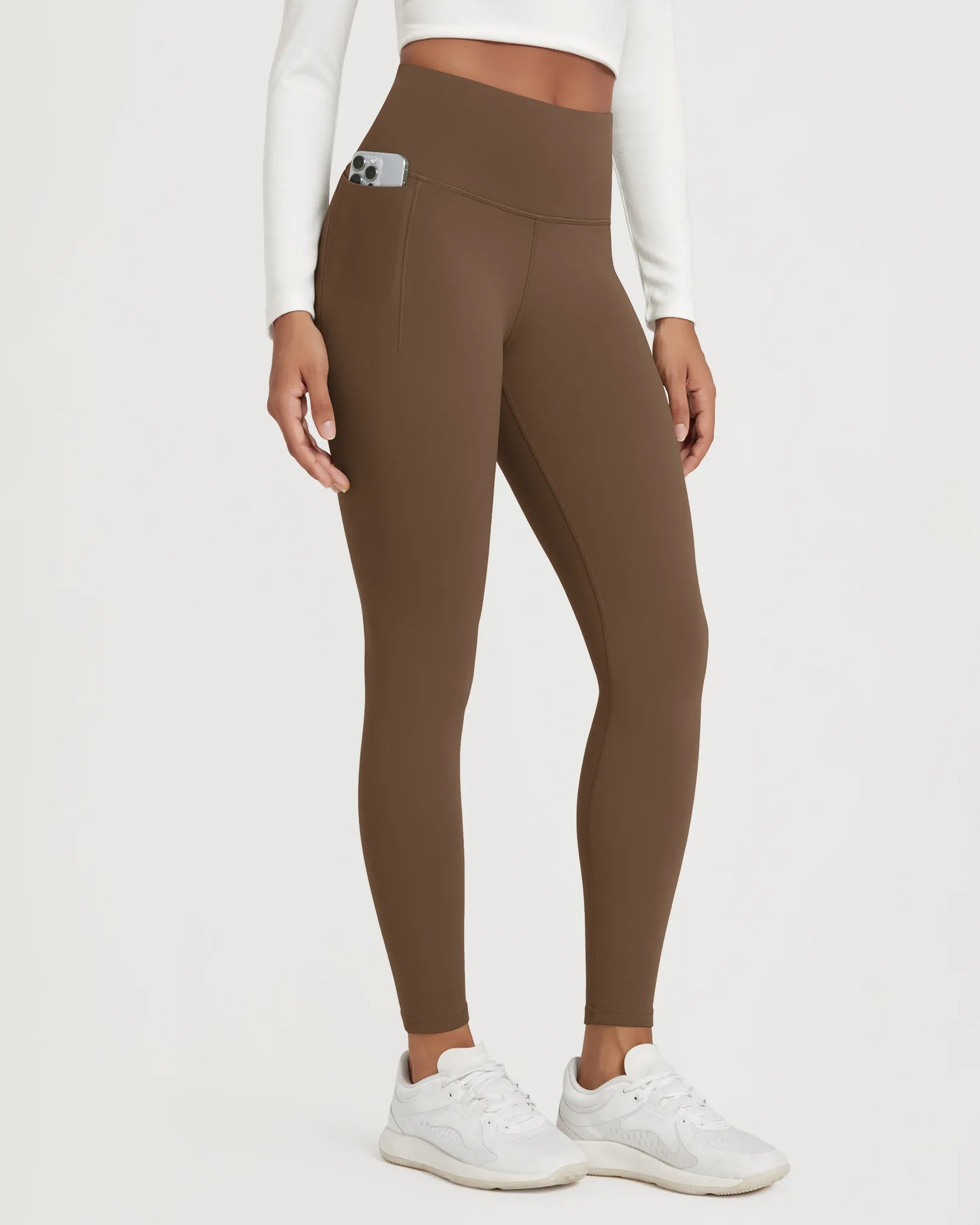 25" Fleece Lined Leggings with Pockets in brown worn by a model showcasing the pocket feature.