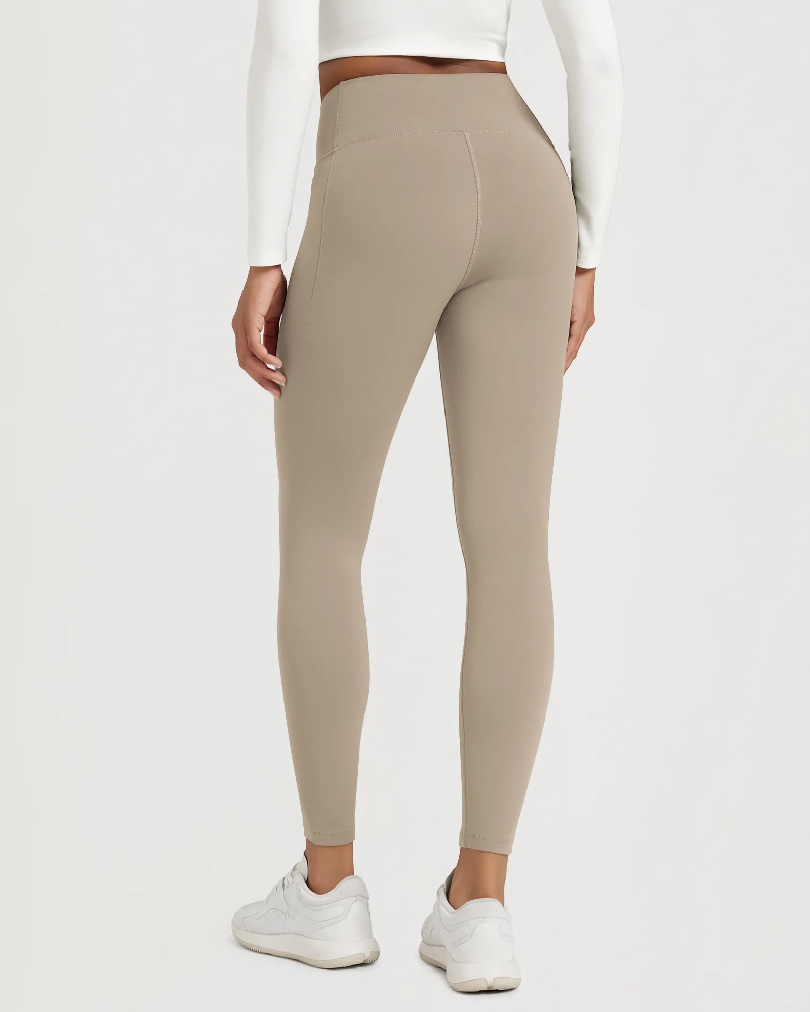 25" Fleece Lined Leggings with Pockets worn by a model from the back, showcasing a comfortable fit and style.