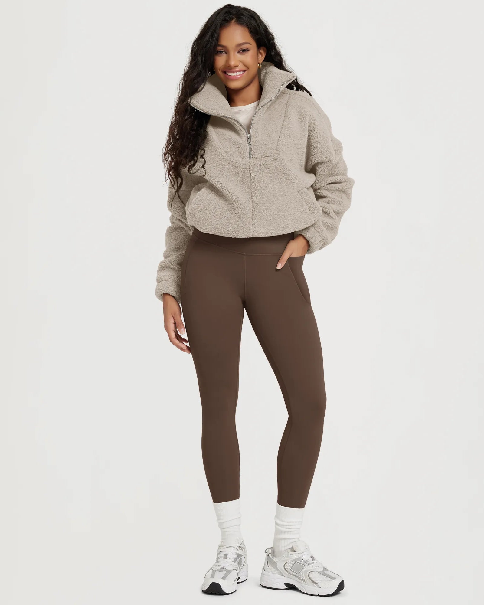 25" Fleece Lined Leggings with Pockets worn by a woman in a cozy outfit.