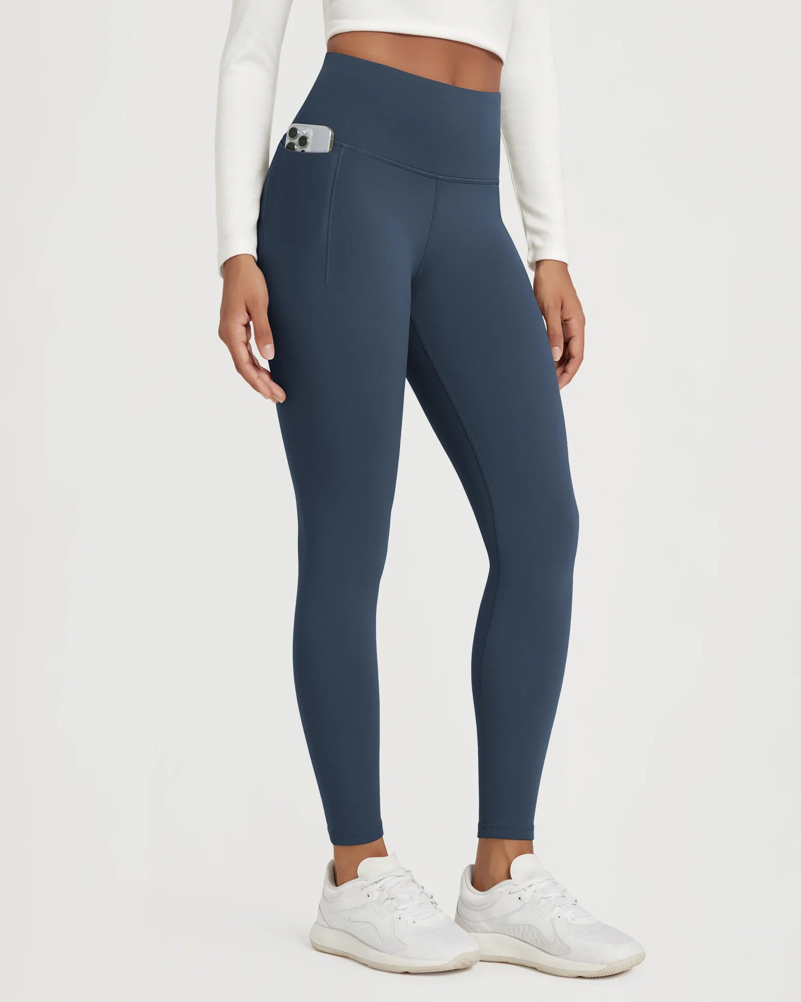 25" Fleece Lined Leggings with Pockets in navy, featuring a high waistband and side pocket for convenience.