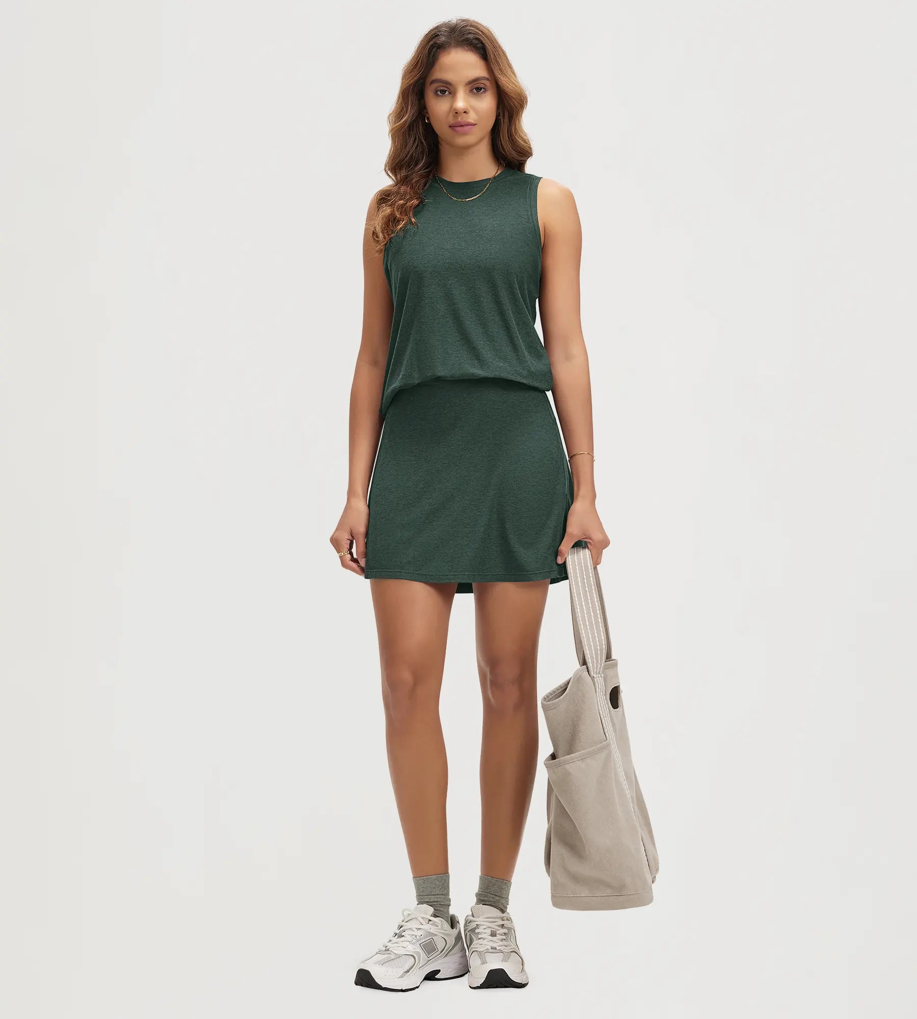 ODODOS Stratum Women's performance tank with matching mini skirt in dark green.