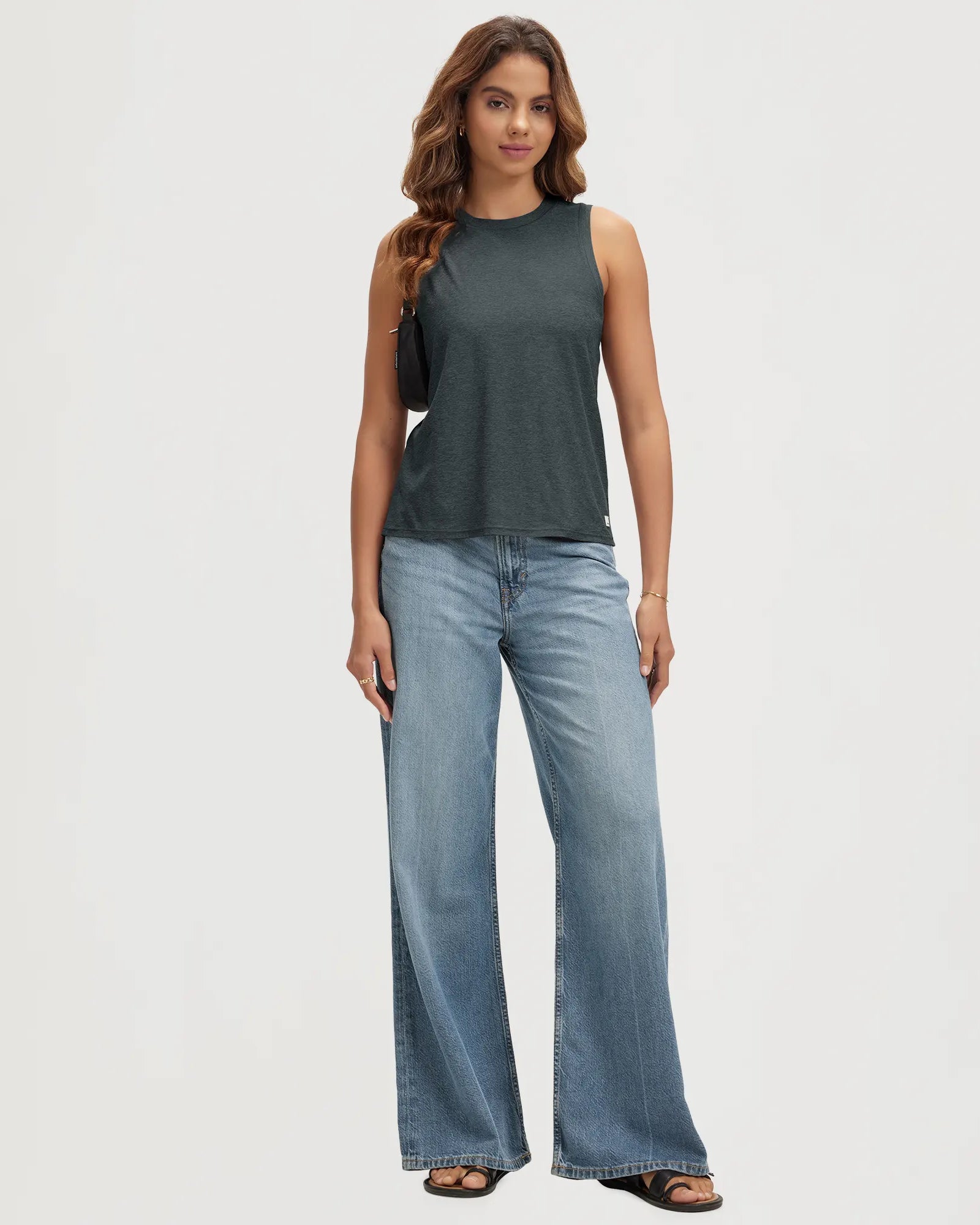 ODODOS Stratum Women's Performance Tank in breathable fabric with wide leg jeans.