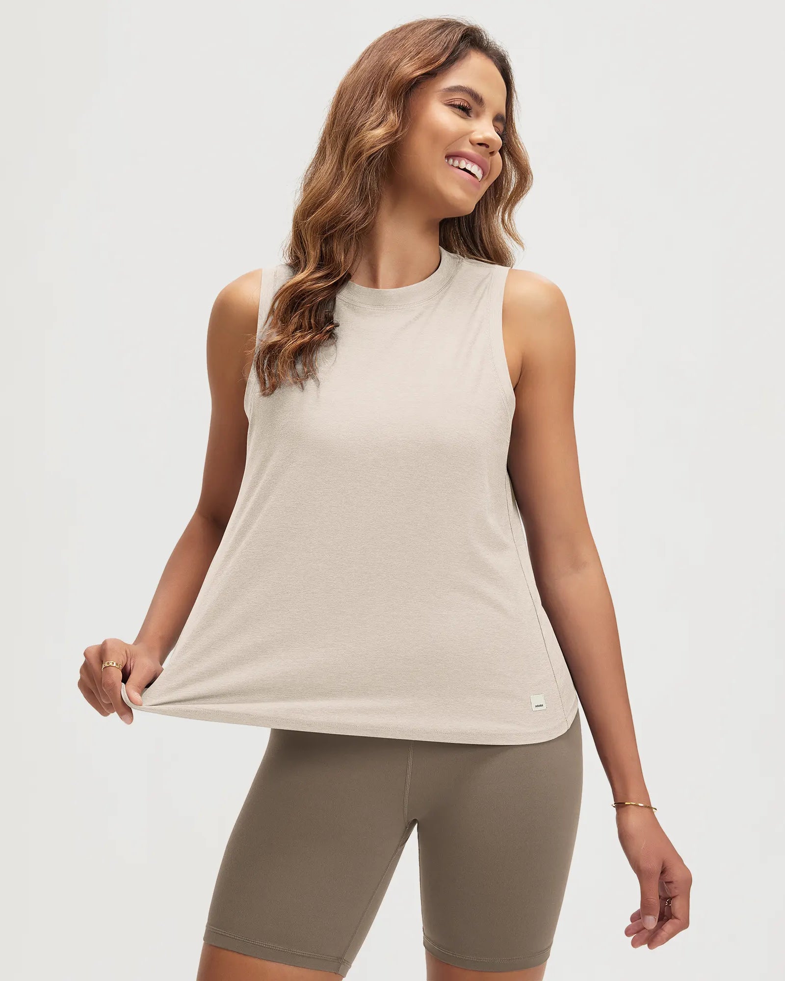 ODODOS Stratum women's performance tank in soft fabric, paired with athletic shorts.