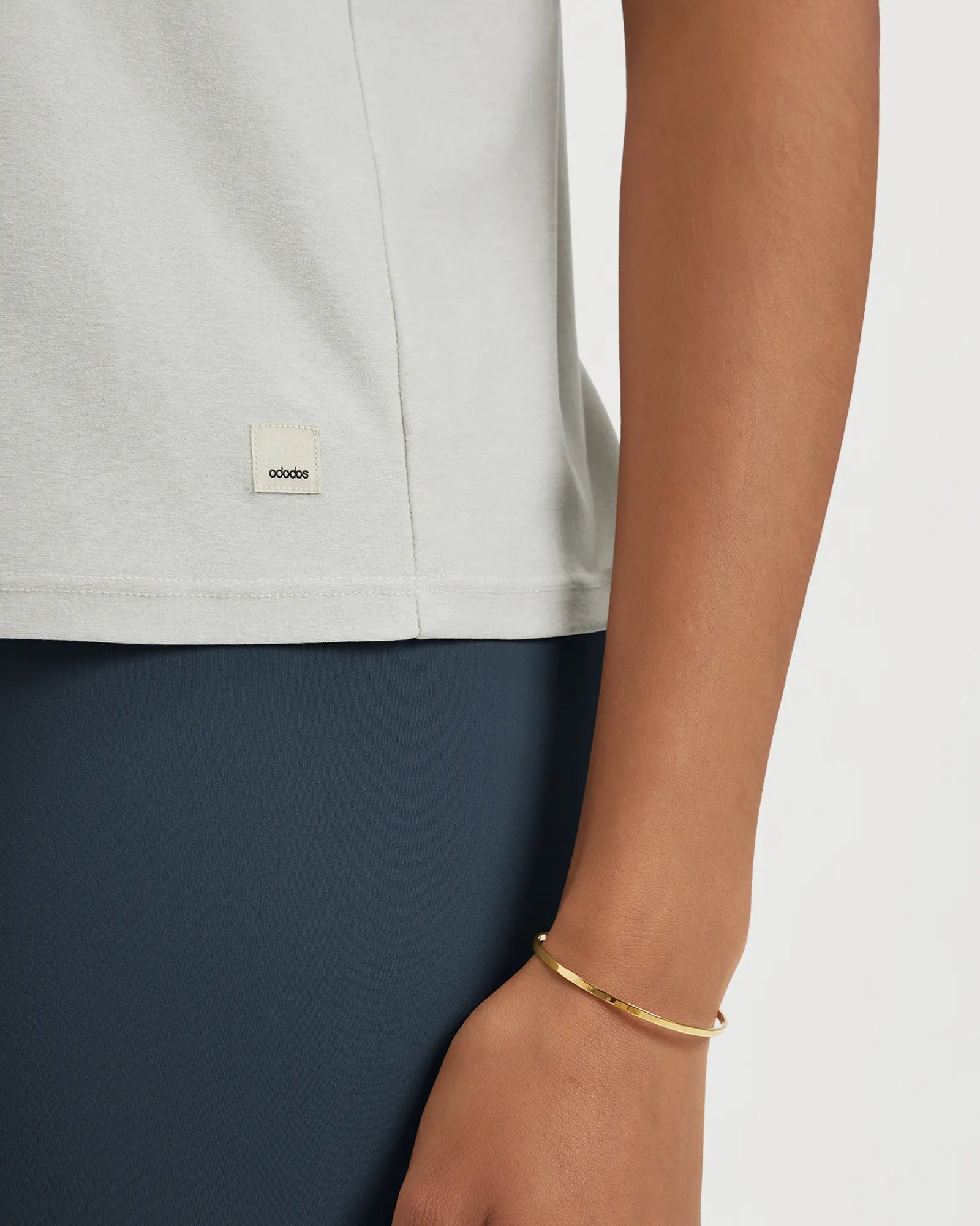 Close-up of ODODOS Stratum performance tank showing soft fabric and brand tag.