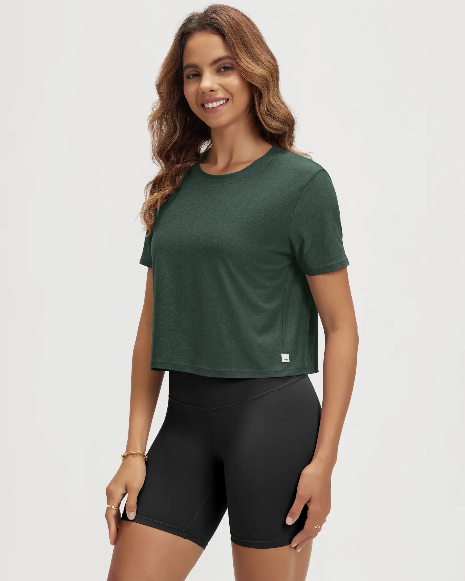 ODODOS Stratum Women's Performance Cropped Tee in green, ideal for workout wear.