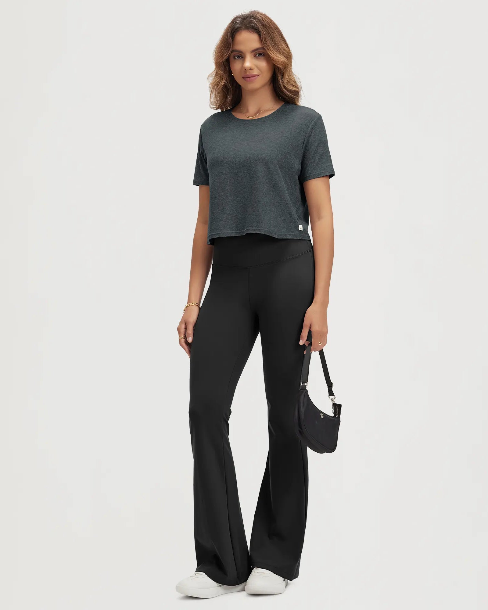 ODODOS Stratum Women's Performance Cropped Tee with black flared pants for workout wear.
