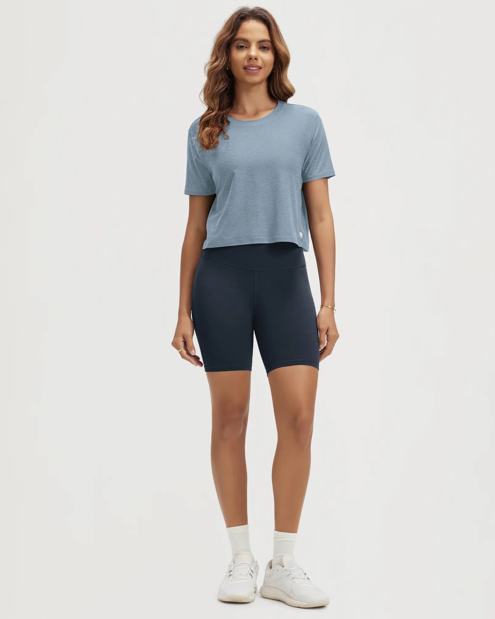 ODODOS Stratum Women's Performance Cropped Tee with athletic fit, paired with bike shorts.