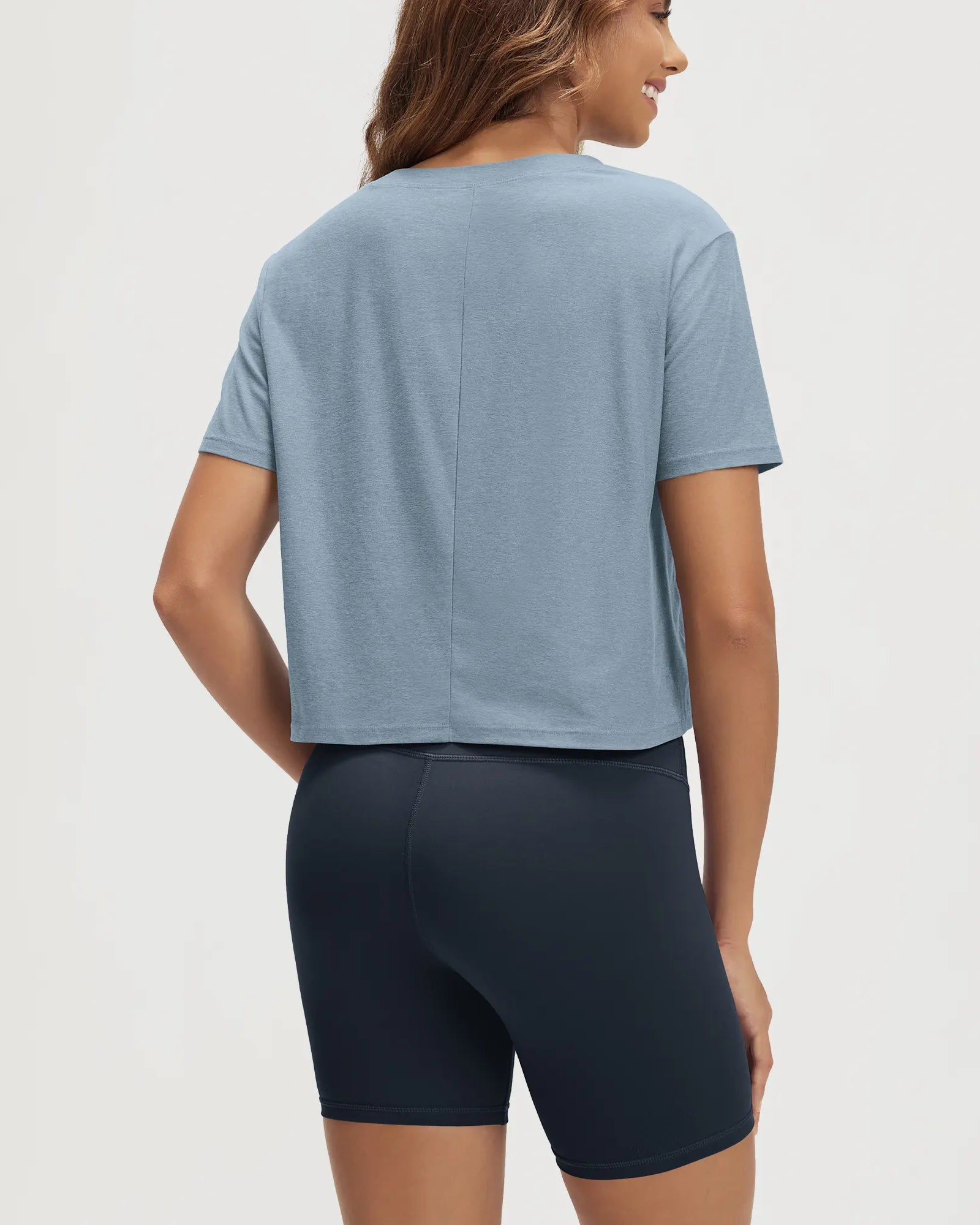 ODODOS Stratum Women's Performance Cropped Tee in soft fabric with workout wear shorts.