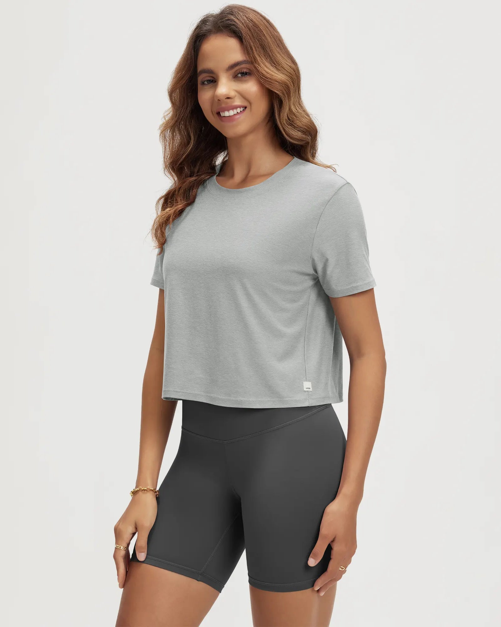 ODODOS Stratum Women's Performance Cropped Tee in soft fabric, paired with workout shorts.