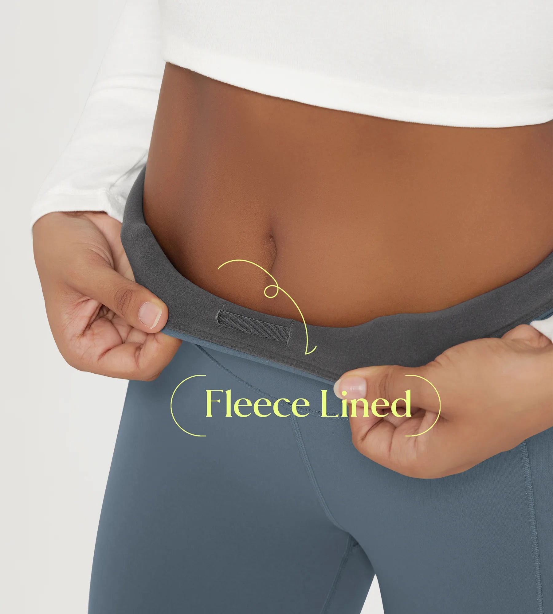 Model showcasing the waistband of 25" Fleece Lined Leggings with Pockets, highlighting the fleece lining detail.