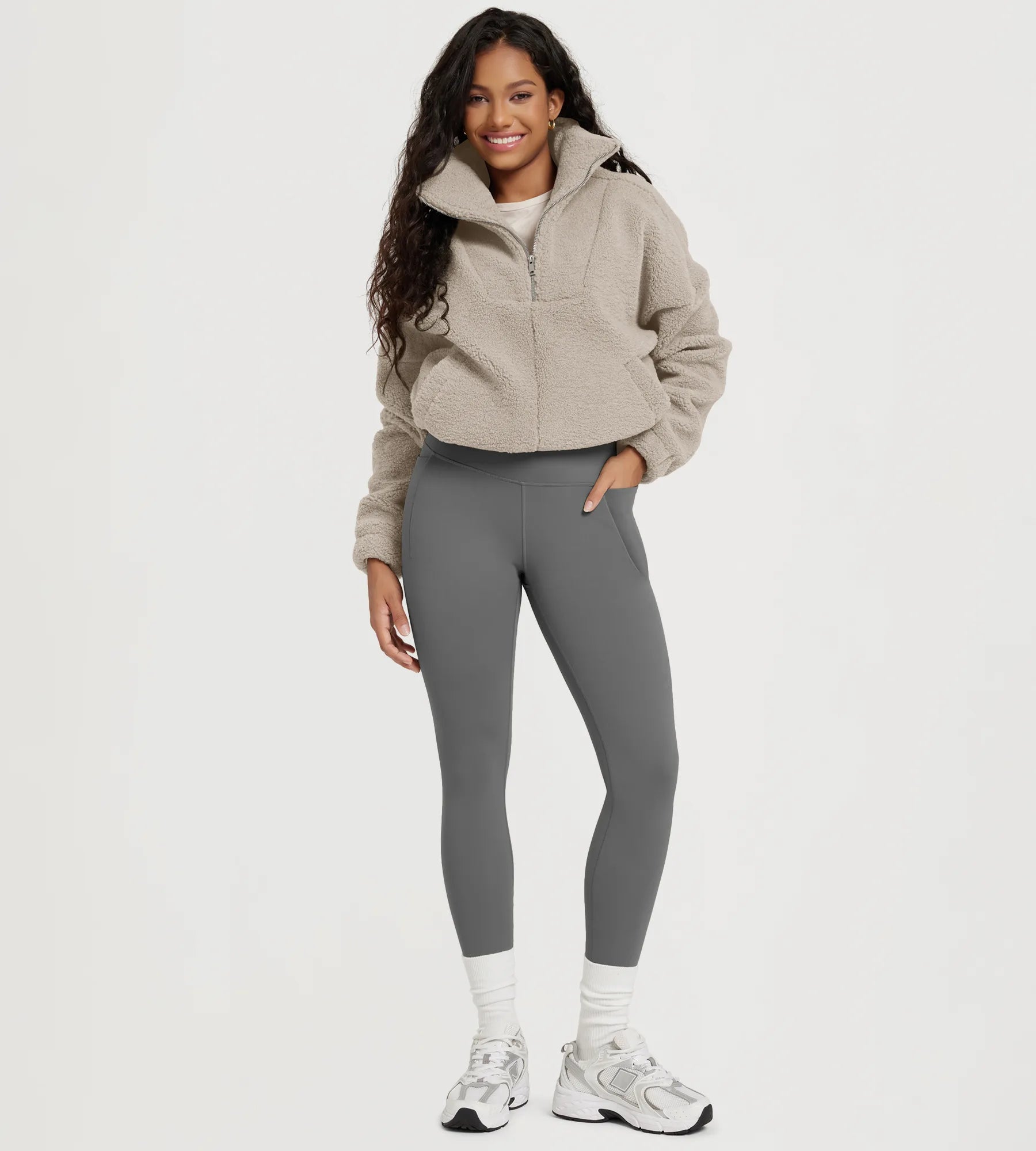 Model showcasing 25" Fleece Lined Leggings with Pockets, paired with a cozy pullover and sneakers.