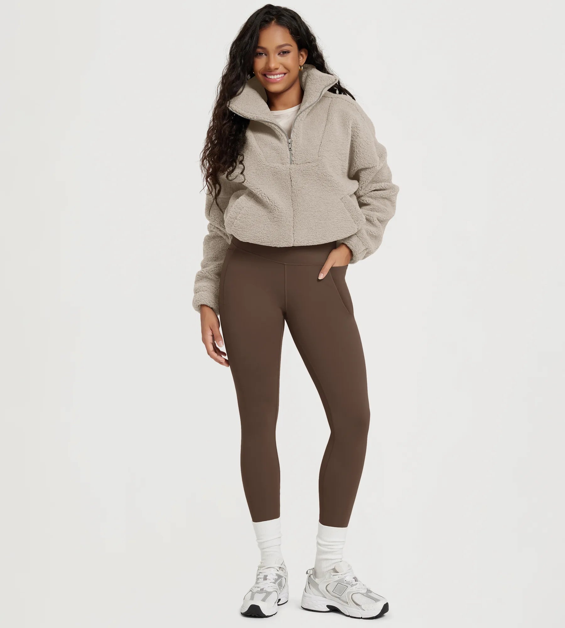 25" Fleece Lined Leggings with Pockets worn by a woman in a cozy outfit.