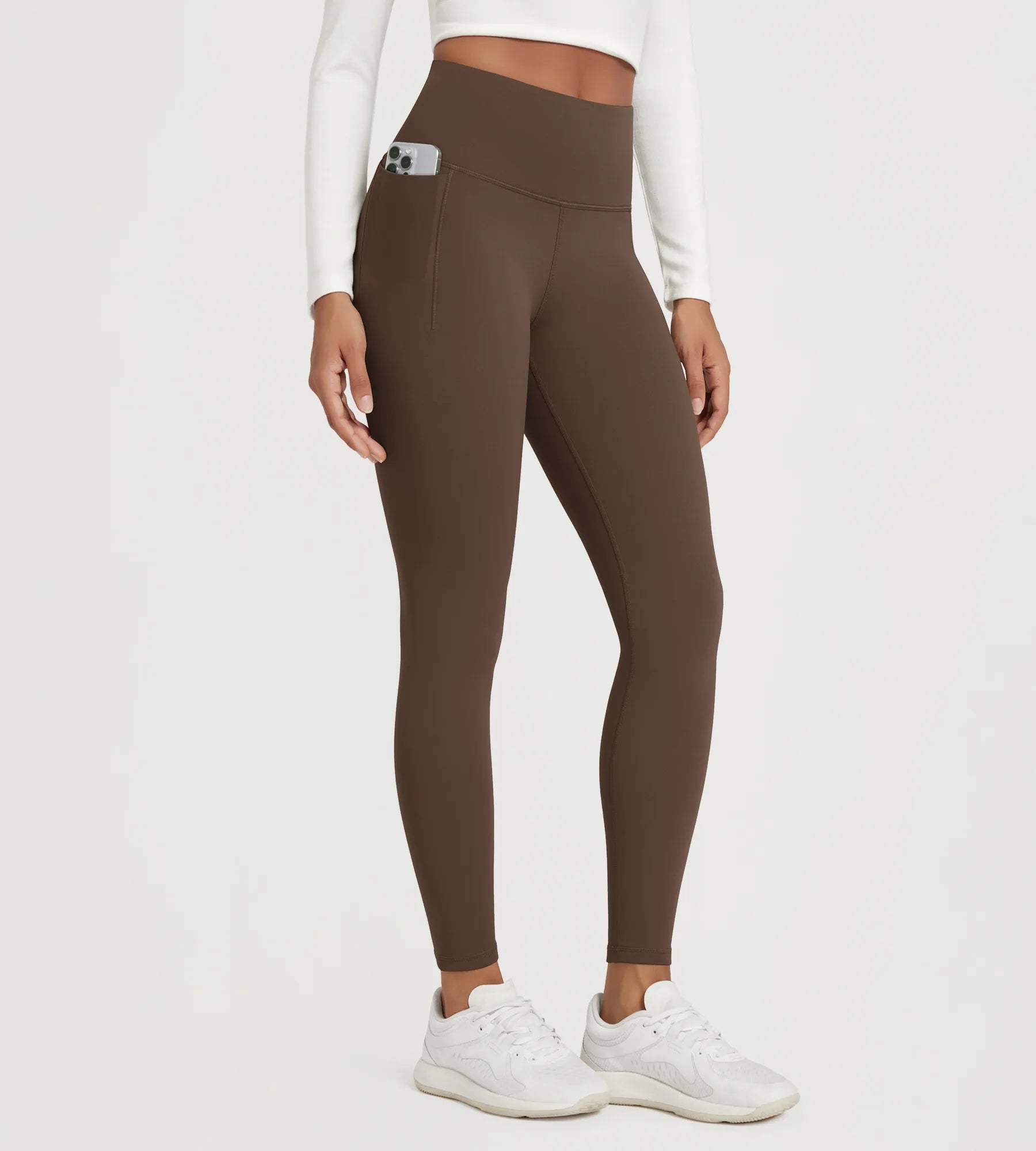 25" Fleece Lined Leggings with Pockets in brown, featuring a sleek design and convenient side pockets.