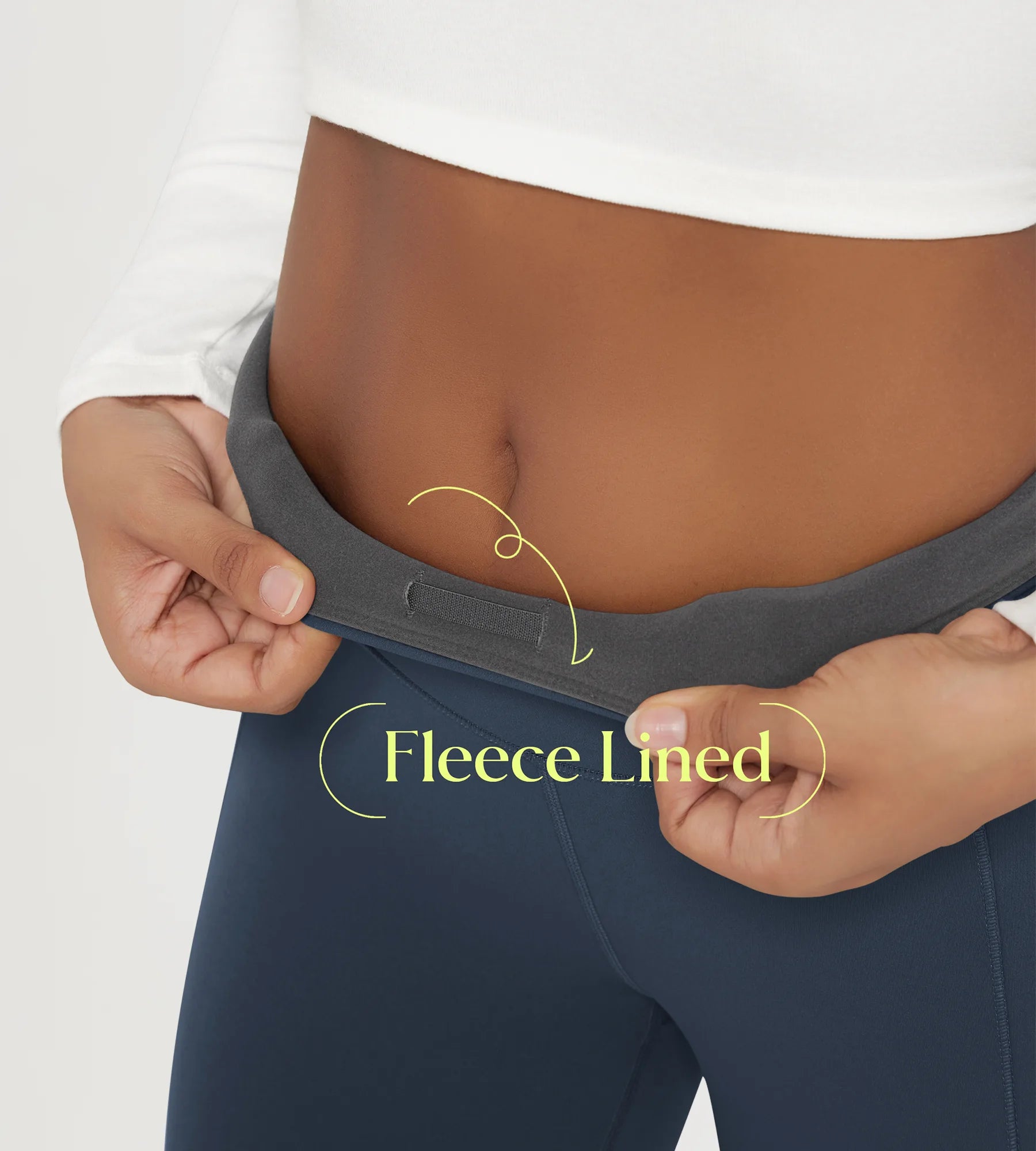 A person showing the waistband of 25" Fleece Lined Leggings with Pockets, highlighting the fleece lining feature.