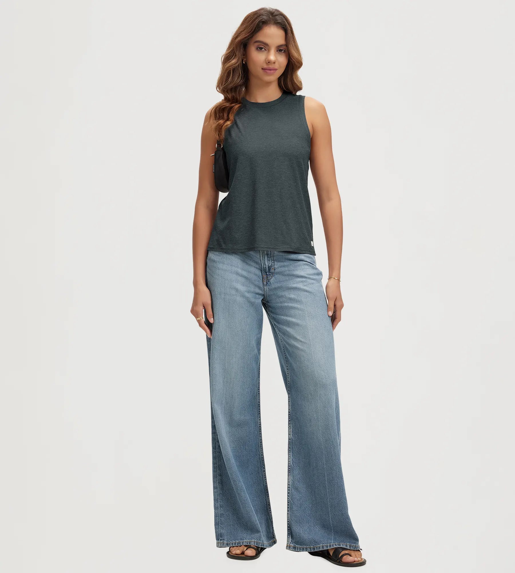 ODODOS Stratum Women's Performance Tank in breathable fabric with wide leg jeans.