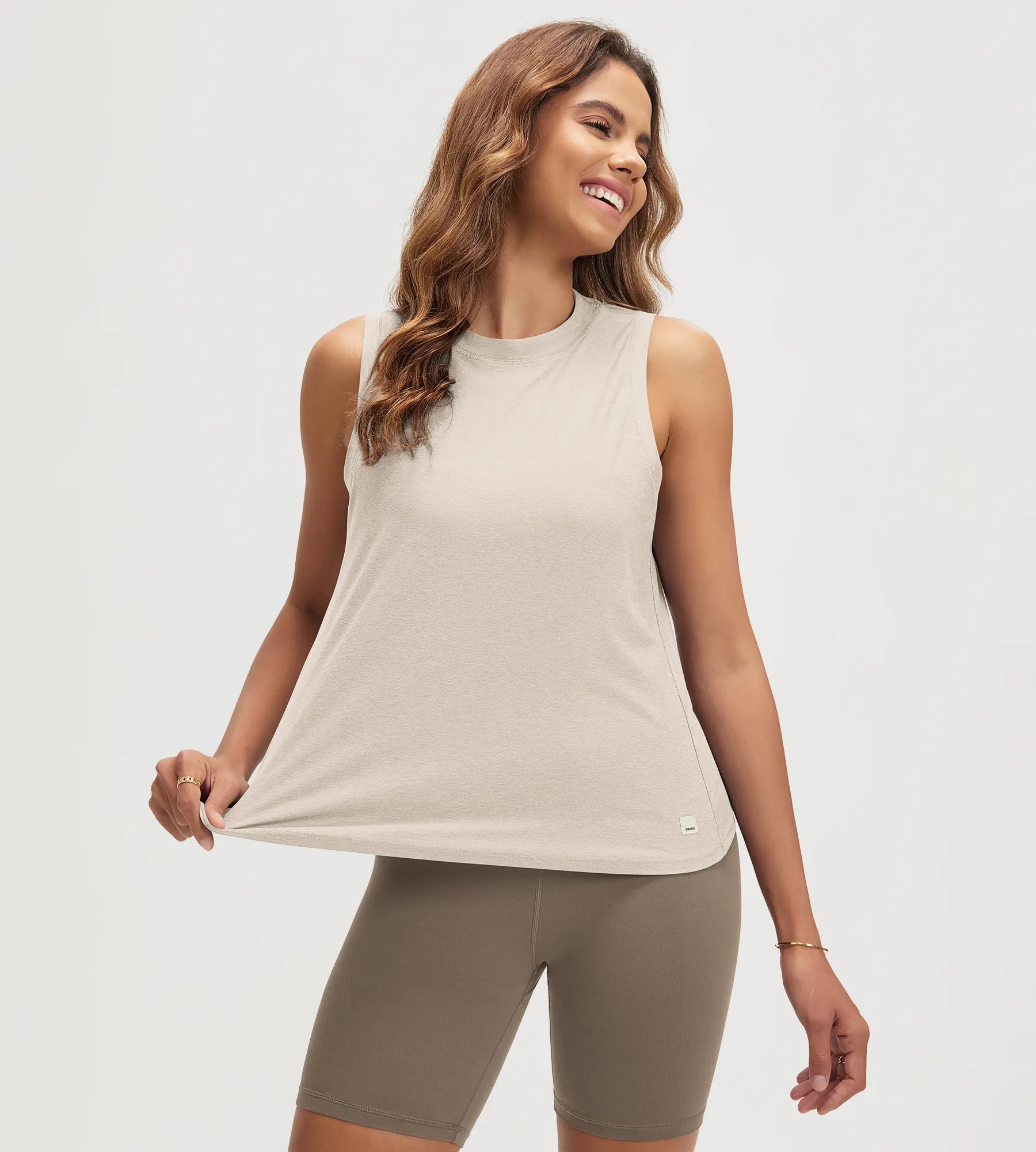 ODODOS Stratum women's performance tank in soft fabric, paired with athletic shorts.
