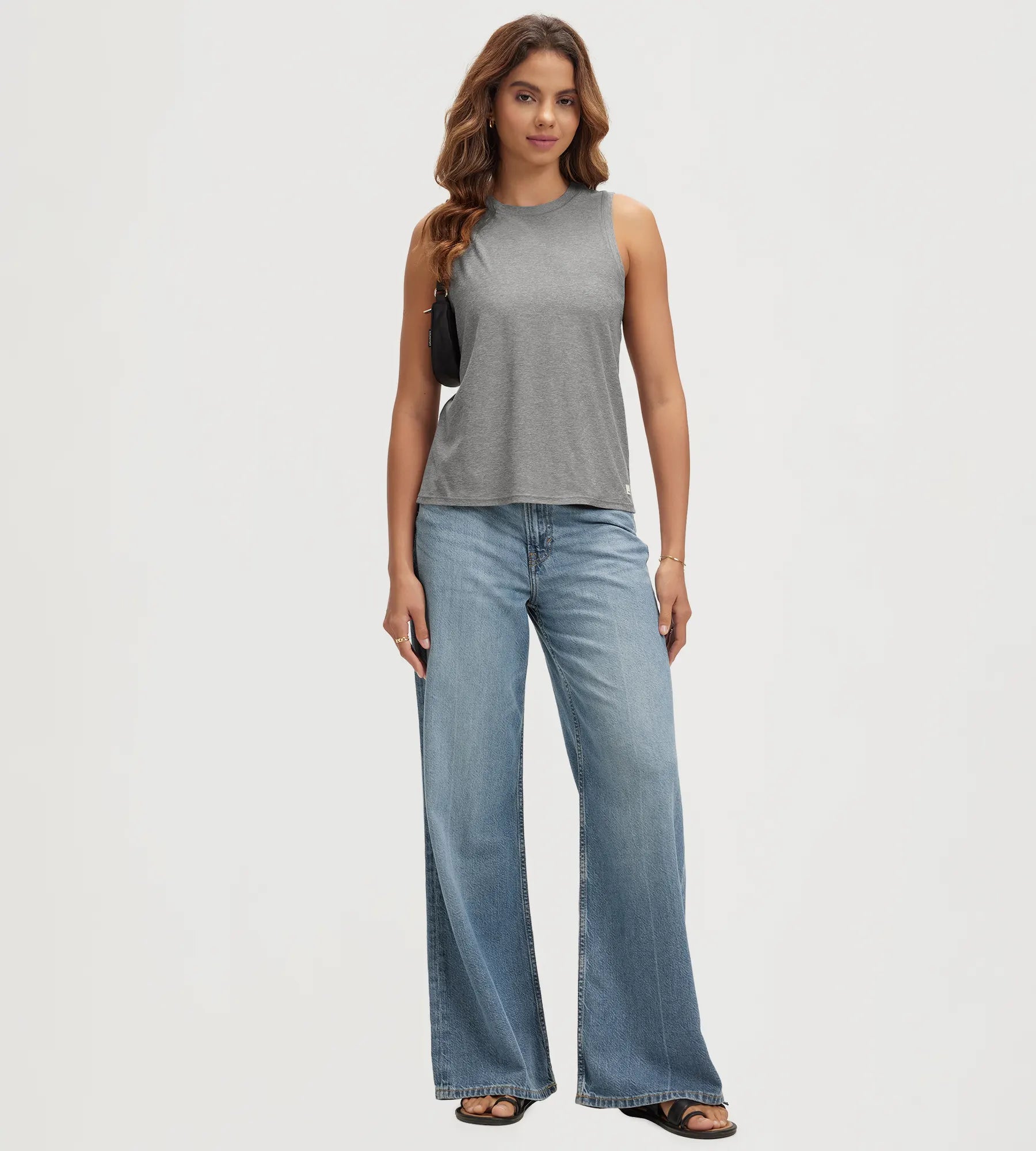 ODODOS Stratum Women's Performance Tank in soft fabric paired with wide-leg jeans.