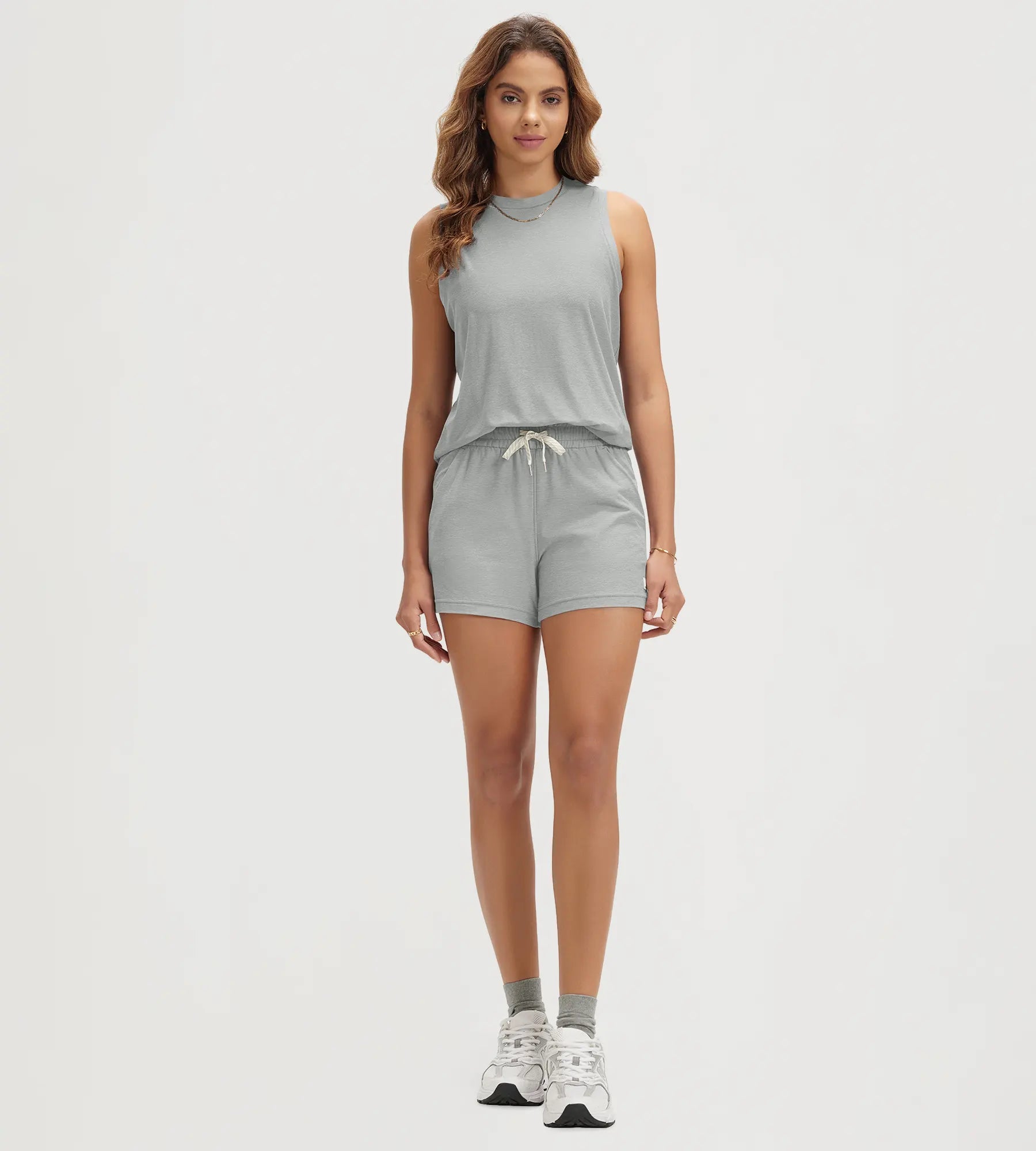 ODODOS Stratum Women's Performance Tank with matching beige athletic shorts.