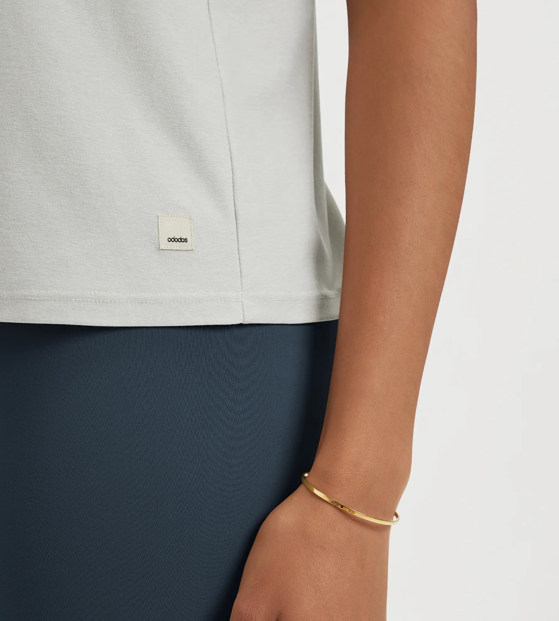 Close-up of ODODOS Stratum performance tank showing soft fabric and brand tag.