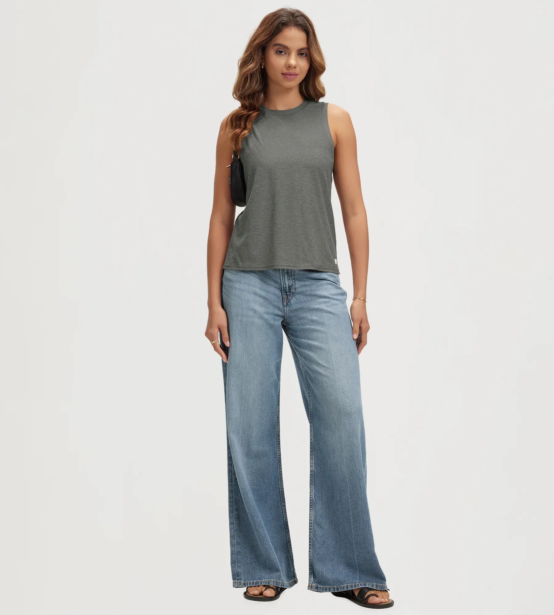 ODODOS Stratum Women's Performance Tank in soft fabric, styled with wide-leg jeans.