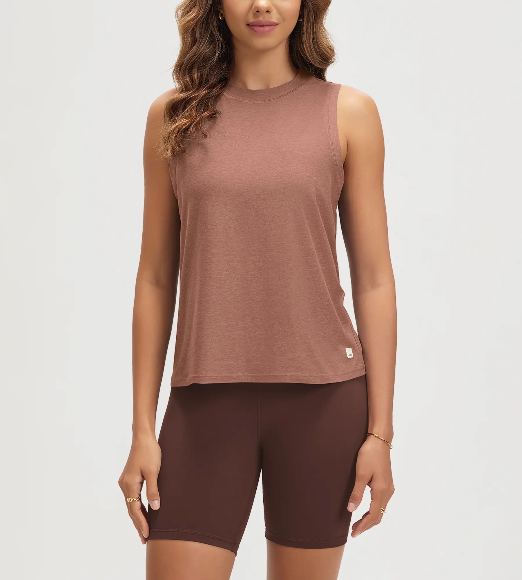 ODODOS Stratum Women's Performance Tank in soft fabric, paired with brown workout shorts.