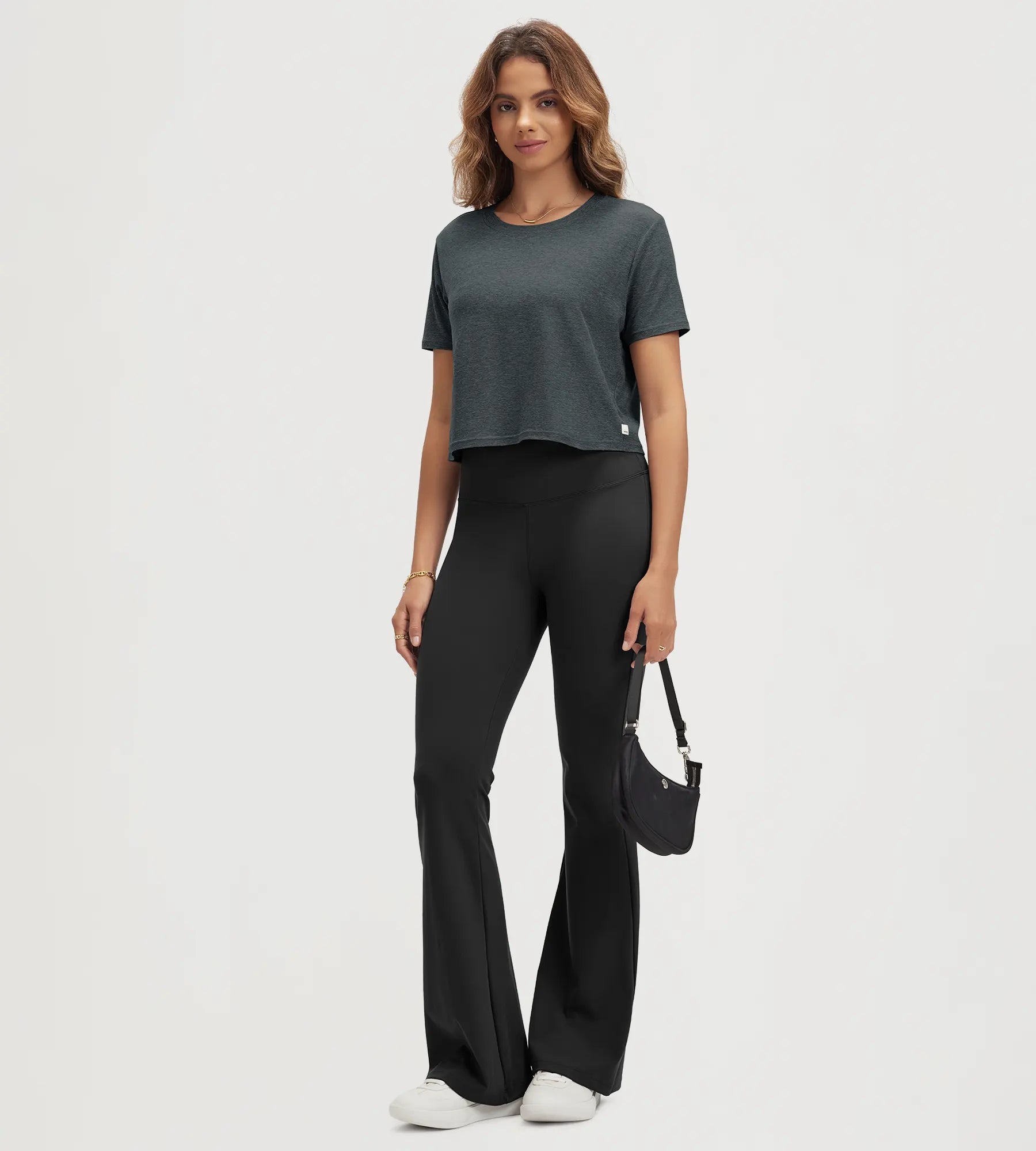 ODODOS Stratum Women's Performance Cropped Tee with black flared pants for workout wear.