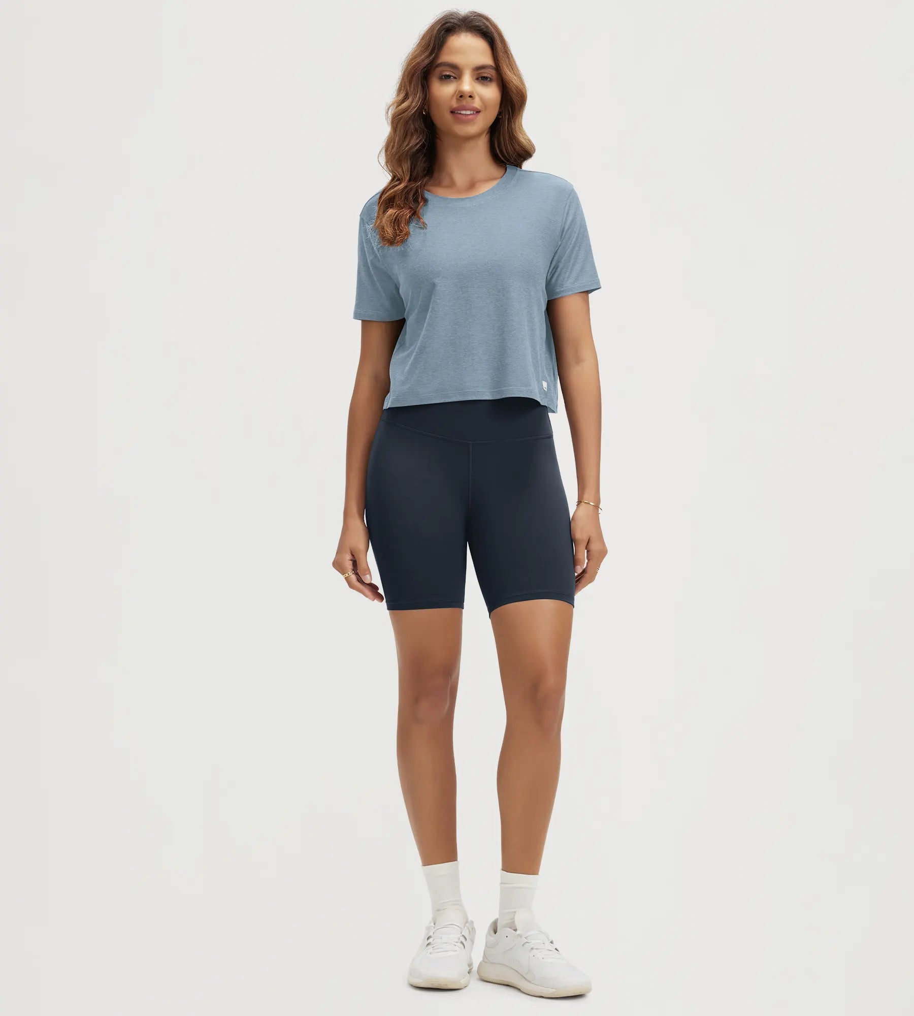 ODODOS Stratum Women's Performance Cropped Tee with athletic fit, paired with bike shorts.
