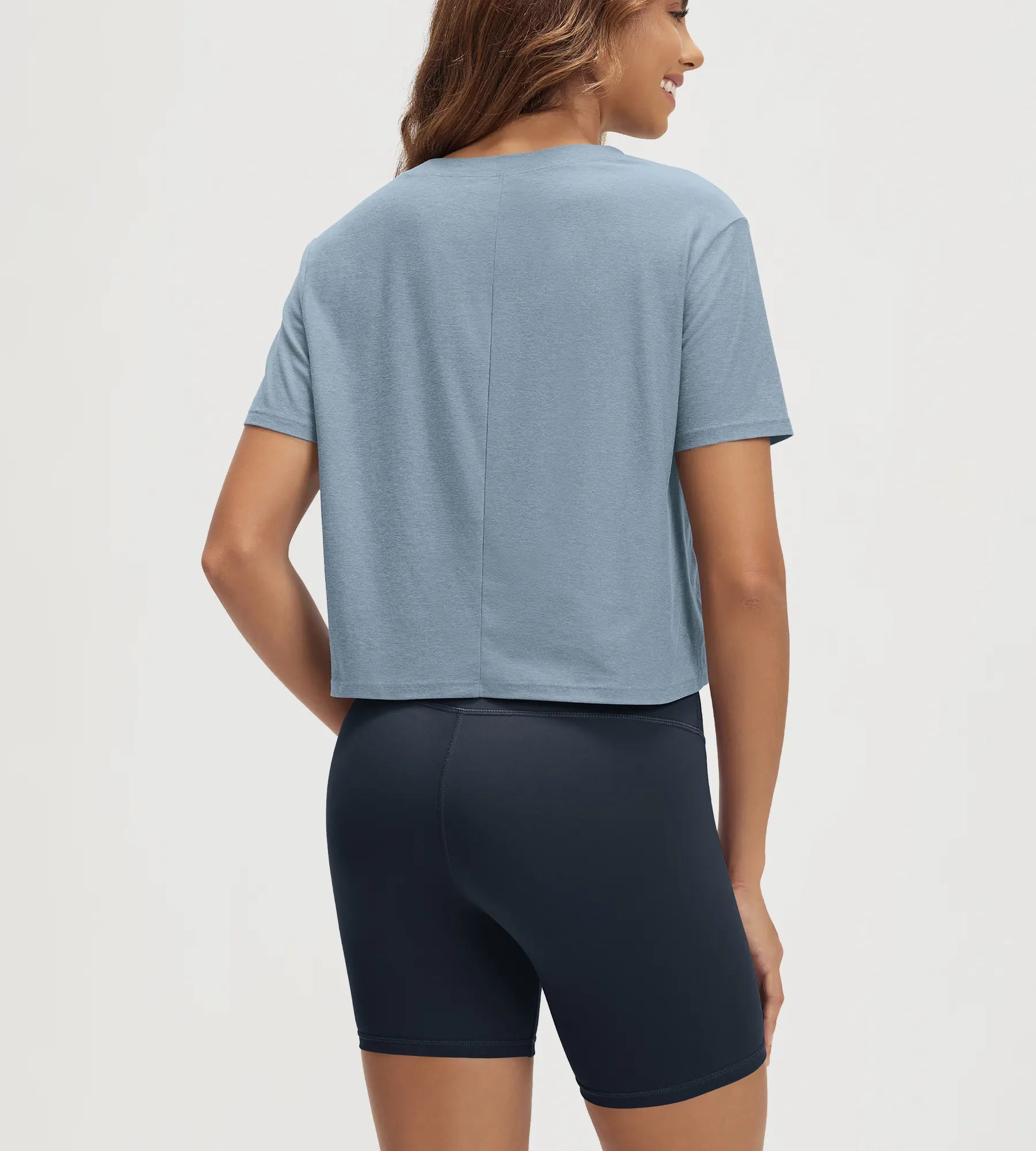 ODODOS Stratum Women's Performance Cropped Tee in soft fabric with workout wear shorts.