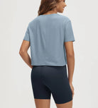 ODODOS Stratum Women's Performance Cropped Tee in soft fabric with workout wear shorts.