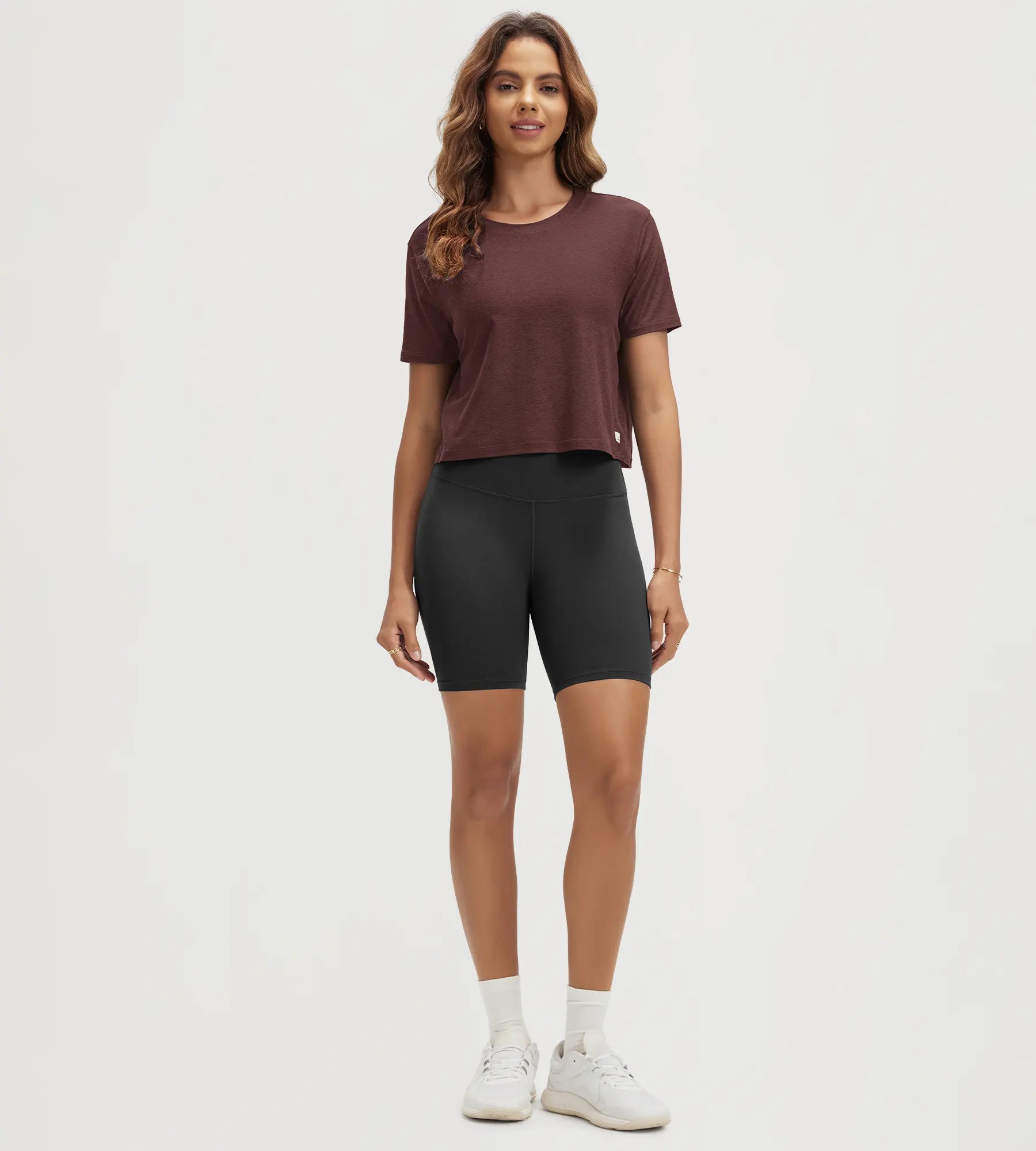 ODODOS Stratum Women's Performance Cropped Tee in soft fabric with workout shorts.