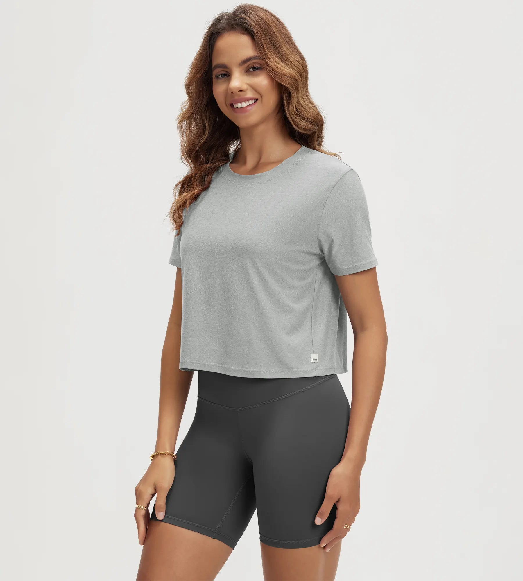 ODODOS Stratum Women's Performance Cropped Tee in soft fabric, paired with workout shorts.
