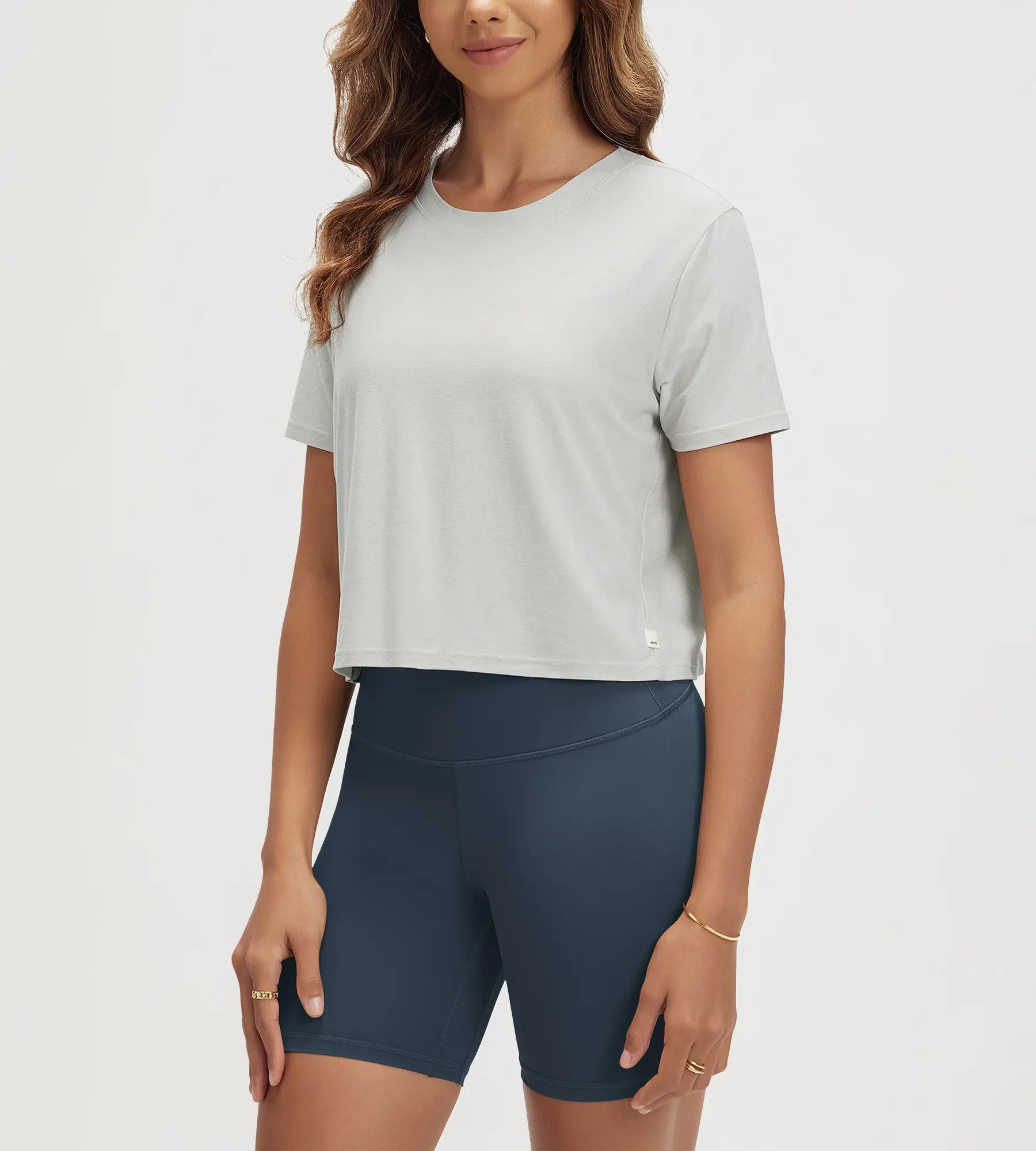 ODODOS Stratum Women's Performance Cropped Tee paired with soft fabric athletic shorts.
